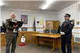 Officiant Reading From a Book Swearing in an Officer
