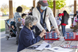 Woman Assisting an Elder with Her Birdhouse Project 3