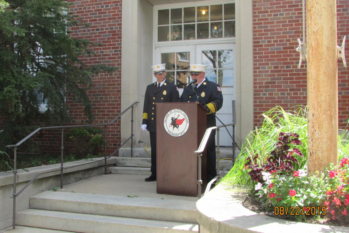 Senior Officers Speaking in Front of Village Hall