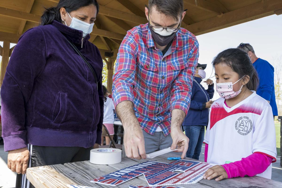 Staff Helping Tape down Part of a Birdhouse 3